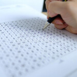 Female Hand Close up Draws Lines On Paper Spell Out And Spell Word